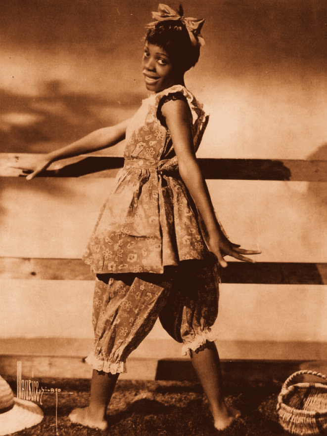 A sepia toned image of a Black woman in a child's costume