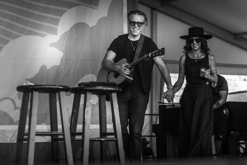 Jason Isbell and Amanda Shires hold hands as they walk onstage in 2021