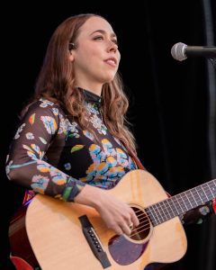 Sarah Jarosz onstage with acoustic guitar
