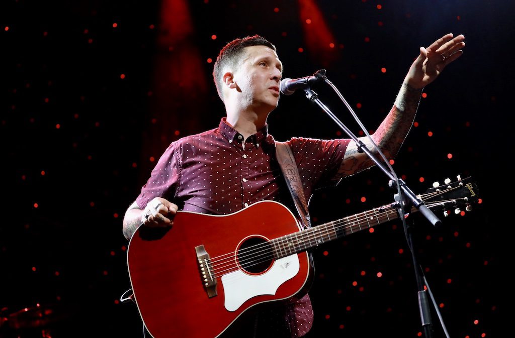 BJ Barham of American Aquarium points while onstage with guitar