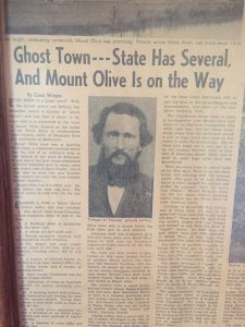 a yellowed newspaper clipping with the headline Ghost Town -- State Has Several and Mount Olive Is on the Way
