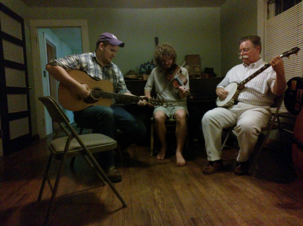 Three musicians seated indoors