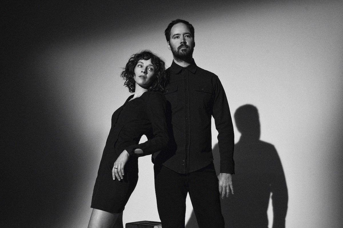 A starkly lit black and white photo of Watchhouse duo Emily Franz and Andrew Marlin