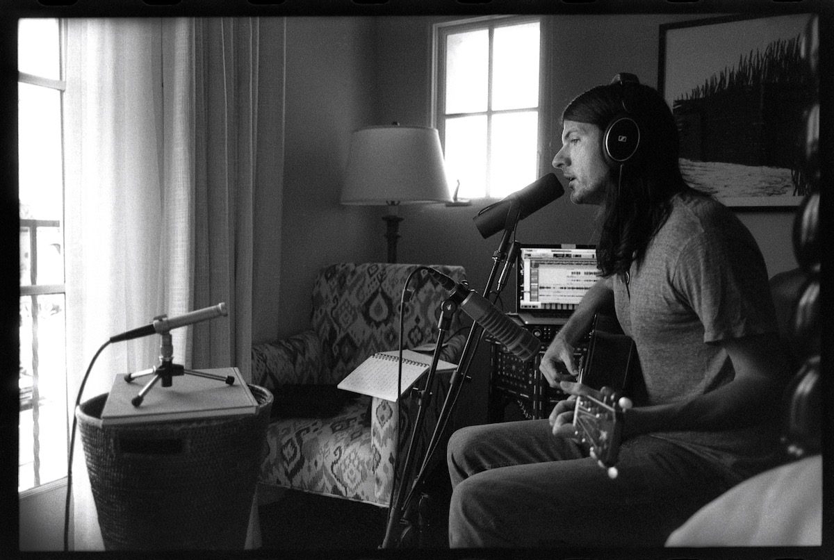 Seth Avett in a hotel room singing into a mic