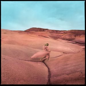 Margo Price in pink dress in a pink desert