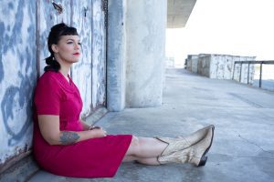 Laura Benitez sits on a concrete dock