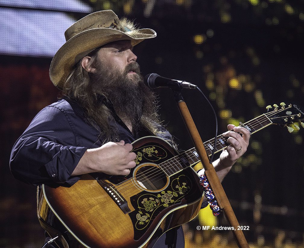Chris Stapleton onstage with acoustic guitar at Farm Aid 2022