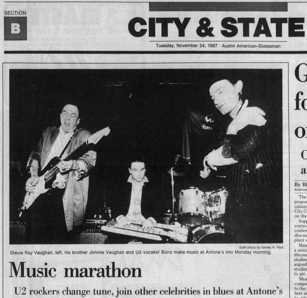 A newspaper clipping with the headline "Music Marathon" and a photo of Bono onstage with Stevie Ray Vaughan.