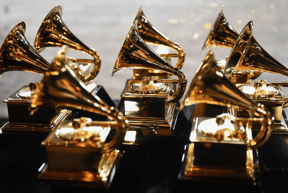 A table filled with golden grammy trophies