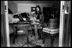 Seth Avett surrounded by recording gear in a hotel room