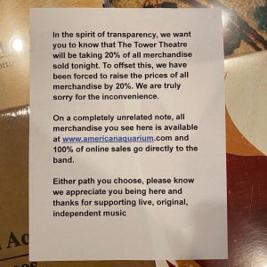 A sign about merch splits posted at the Tower Theatre by American Aquarium