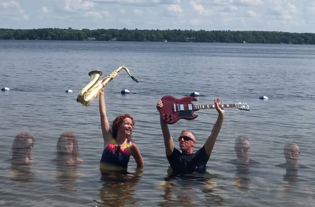 Red Dirt Skinners hoisting their instruments over some water