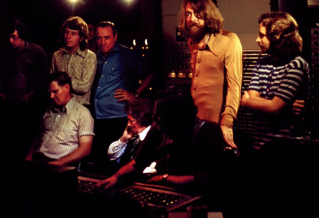 Nitty Gritty Dirt Band and musical guests listen in a recording studio control room