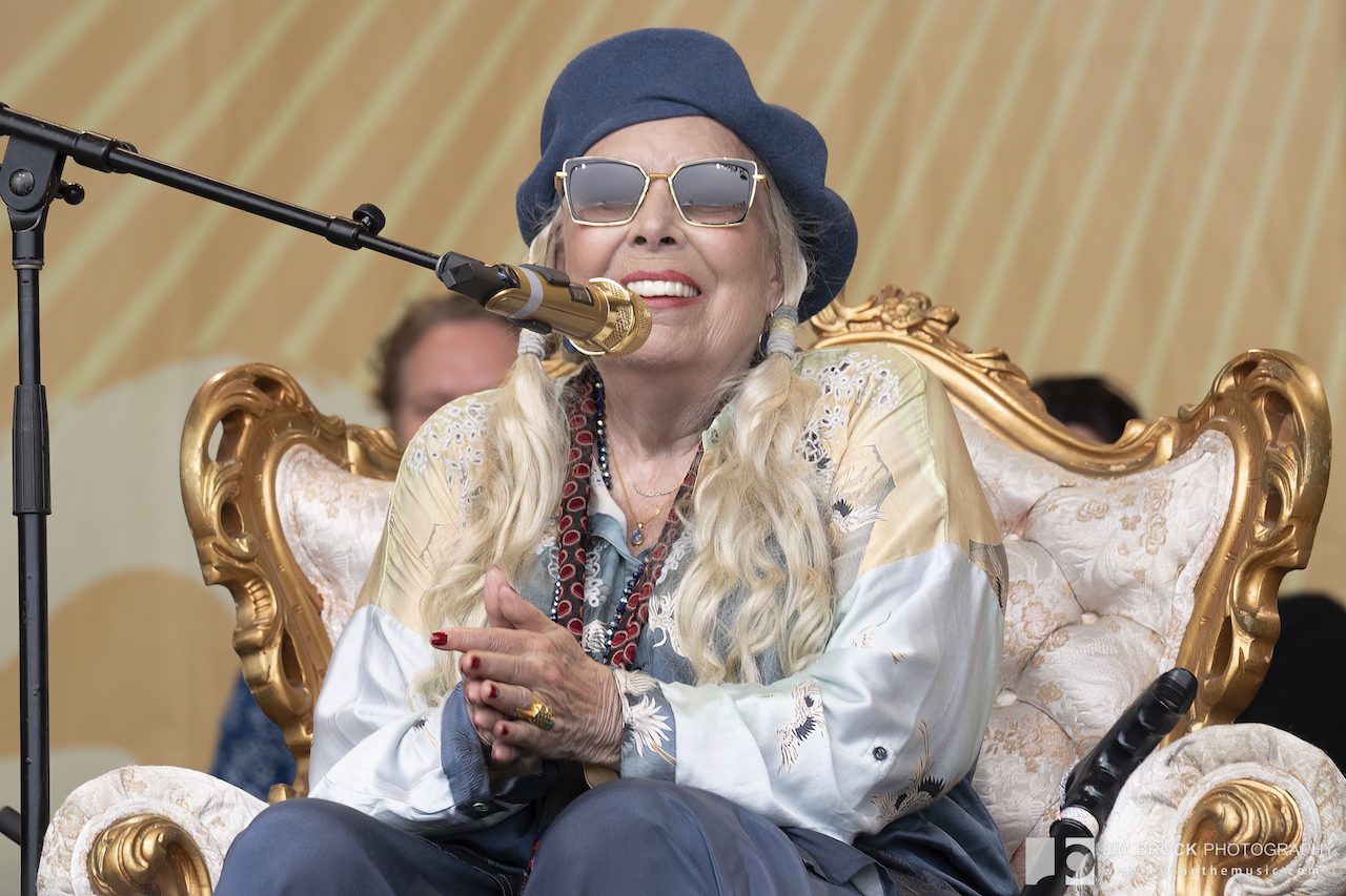 Joni Mitchell seated onstage at Newport Folk Festival