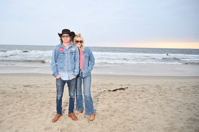 Two people wearing denim on a beach