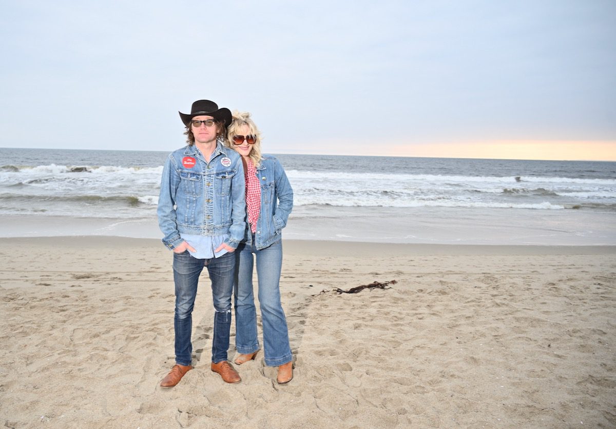 Two people wearing denim on a beach