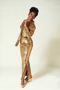 Full length portrait of Carla Thomas in gold sequined dress with jacket