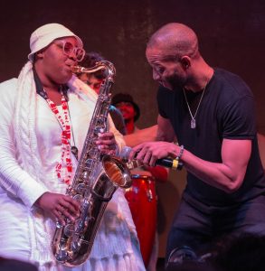 Trombone Shorty and Cimafunk saxophonist Katerin Llerena perform onstage.