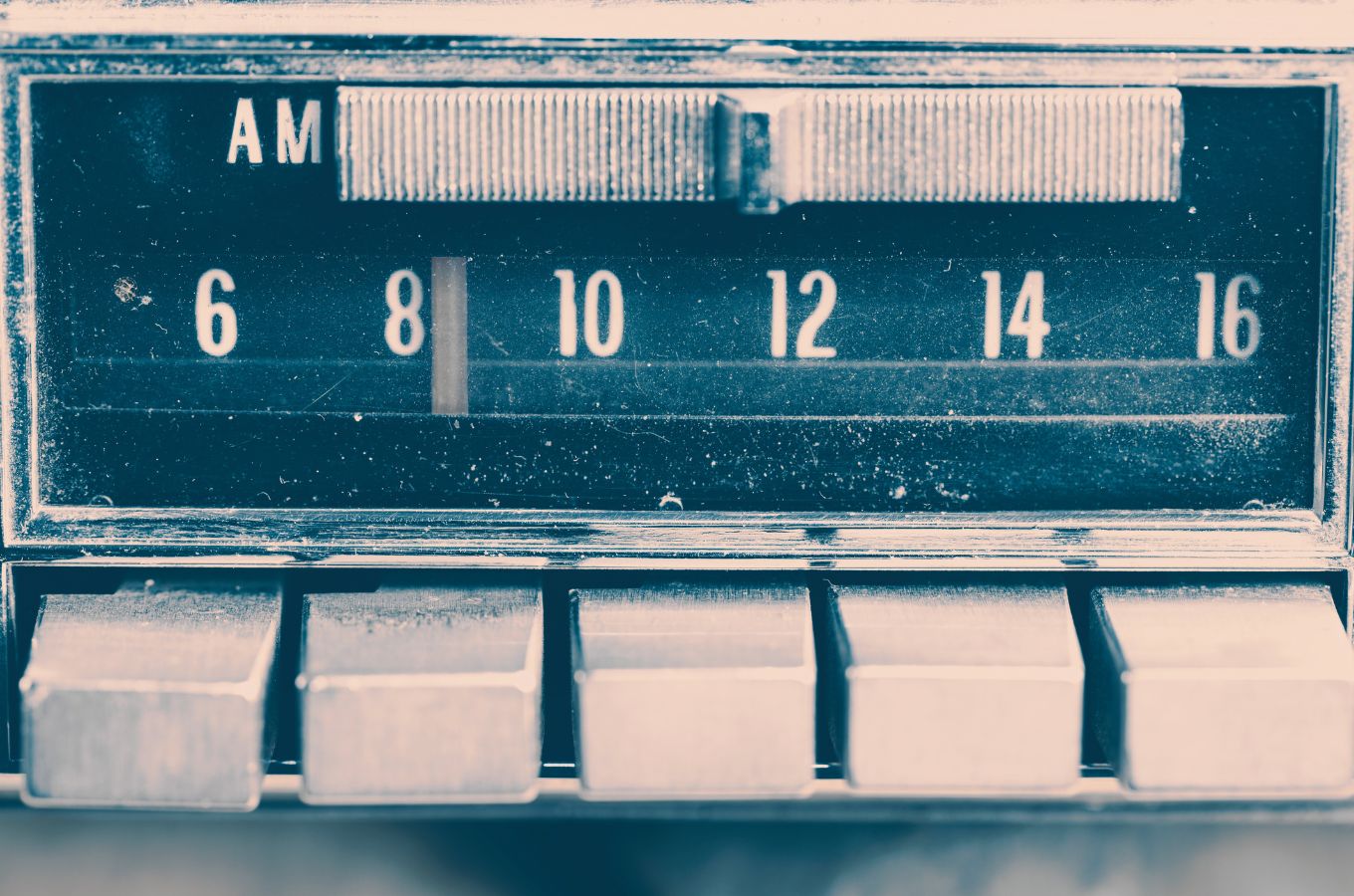 Pink-toned image of a vintage car AM radio