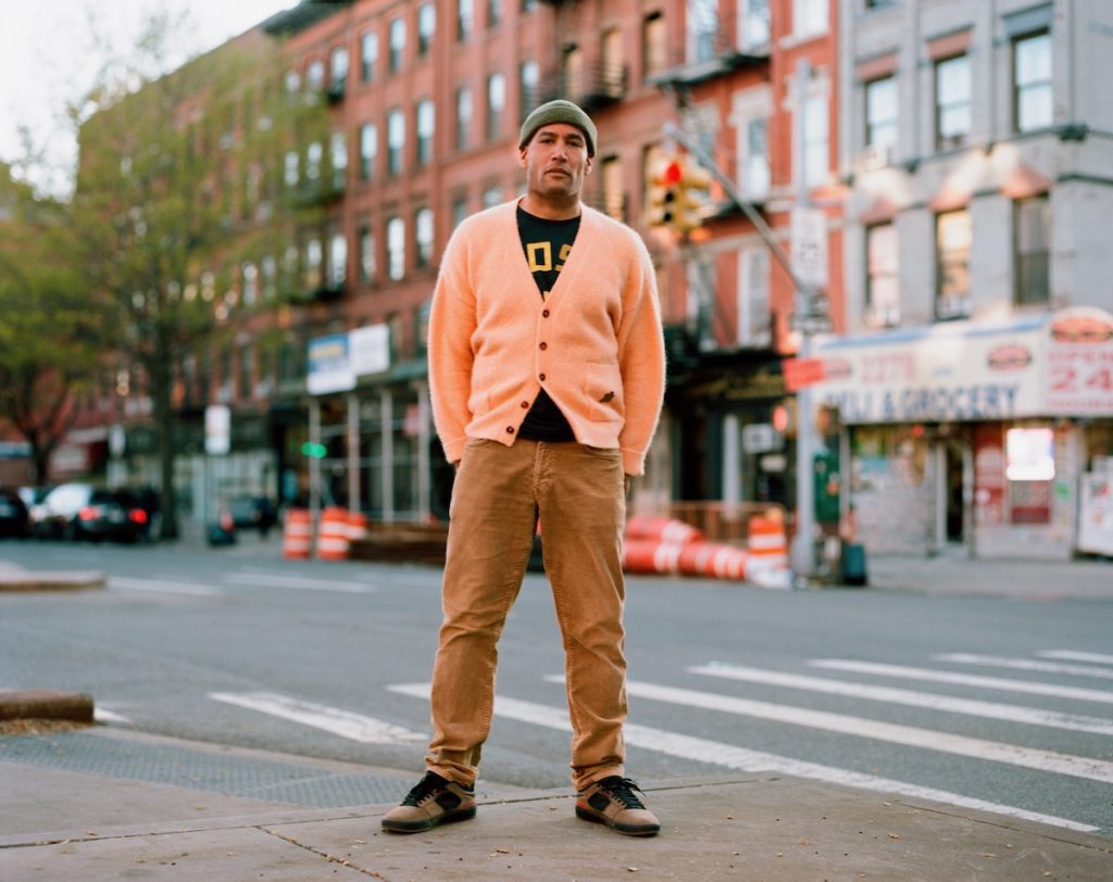 Ben Harper stands on a Harlem street corner