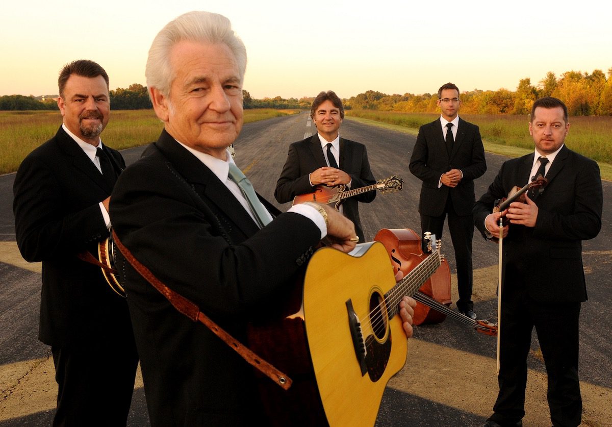 The Del McCoury Band on a road with golden light