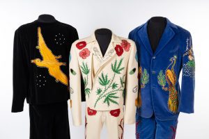 Three elaborately embroidered suits with sequins