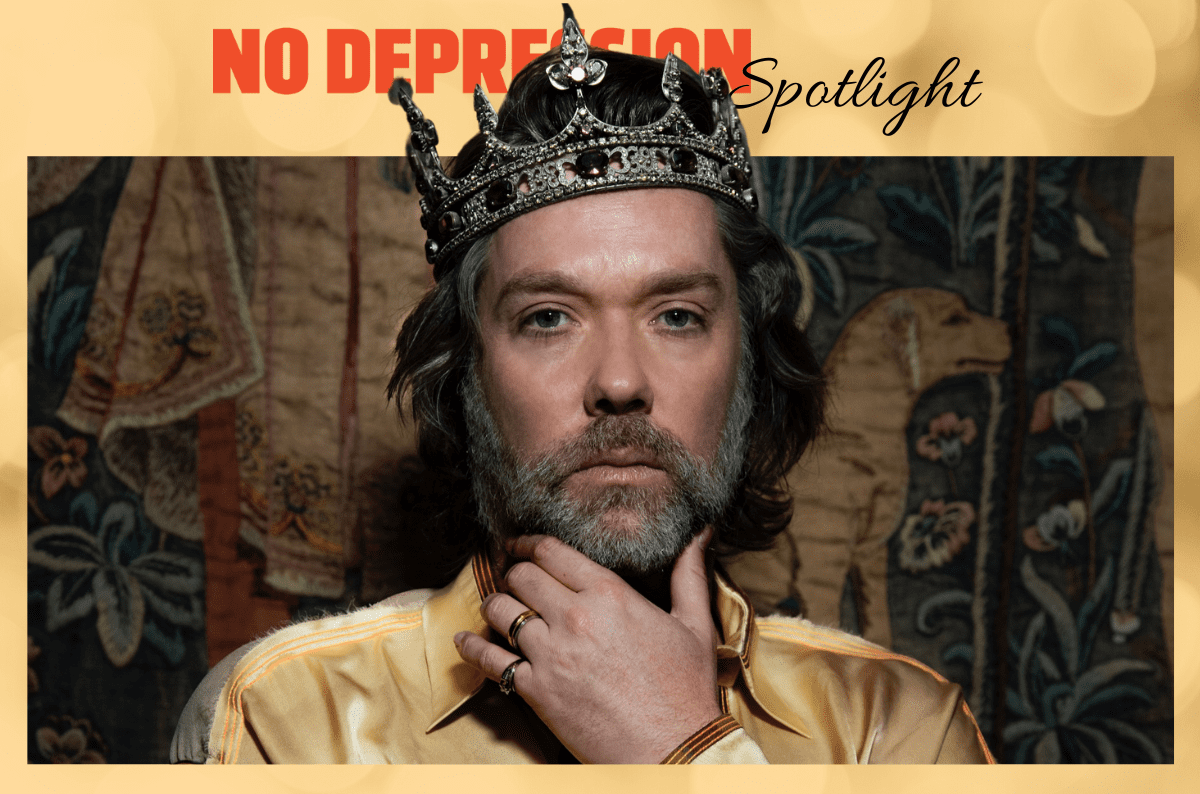 Rufus Wainwright wearing a crown in a graphic labeled No Depression Spotlight