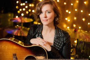 Laura Cantrell portrait with acoustic guitar