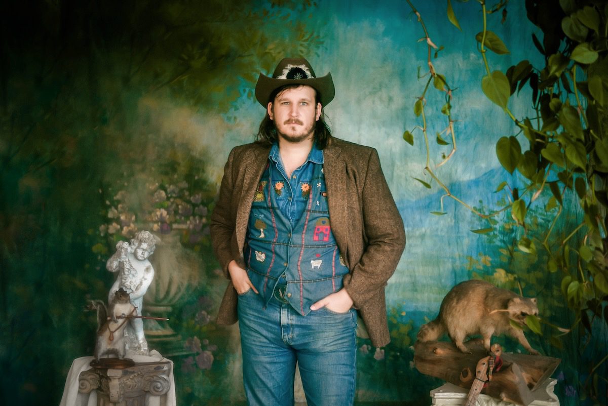 Willi Carlisle stands amid taxidermied animals and other items