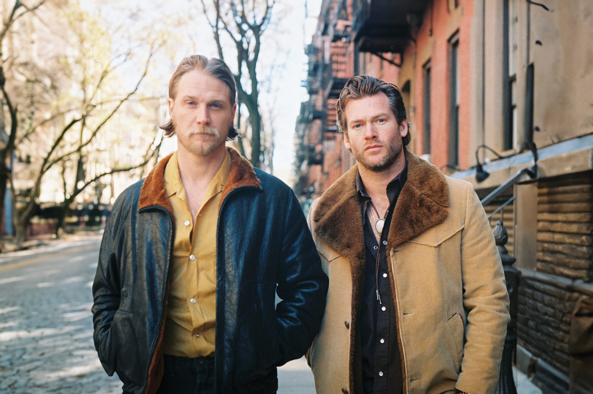 The duo of Jamestown Revival on a city sidewalk