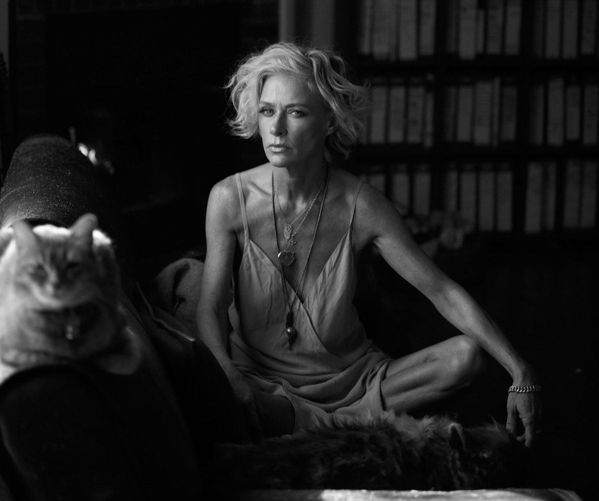 black and white portrait of Shelby Lynne sitting on a sofa