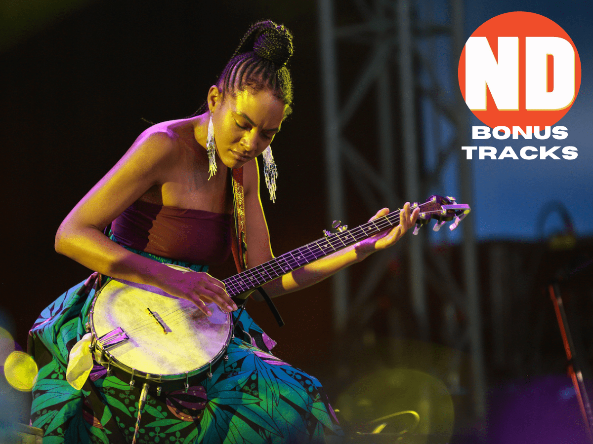 Allison Russell tenderly plays banjo onstage