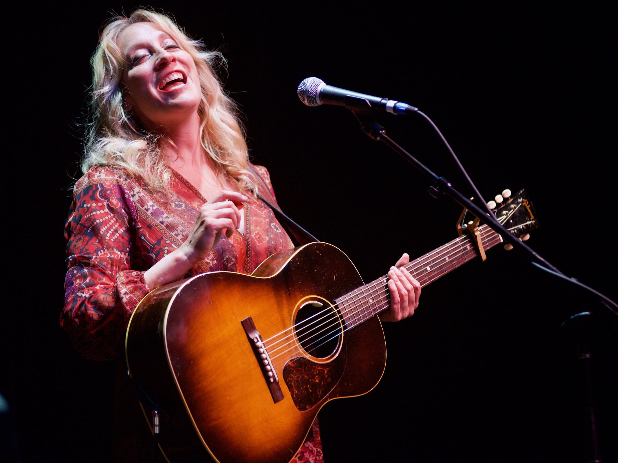 Amy Speace onstage with acoustic guitar