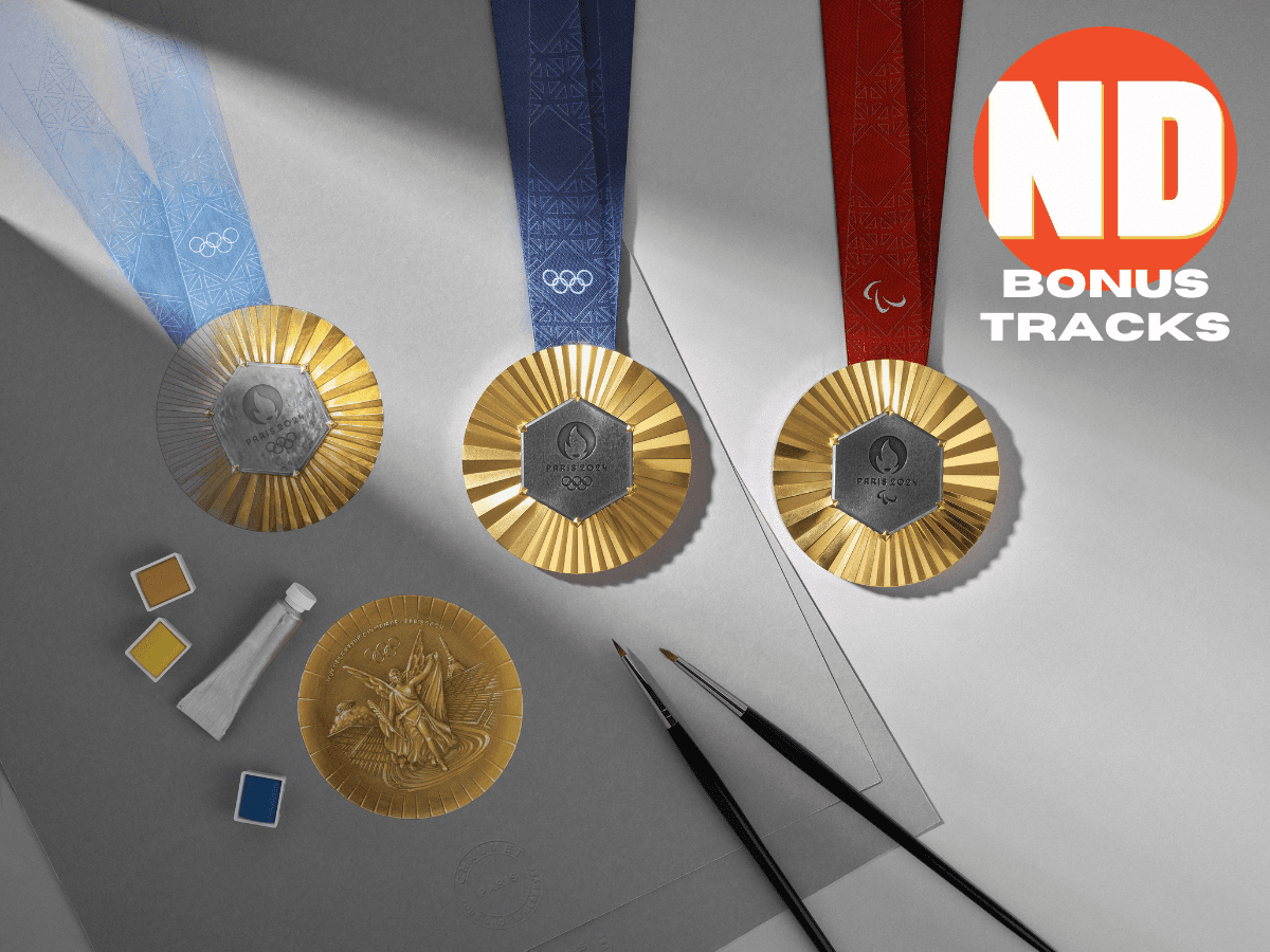 Olympic medals arranged with paints and brushes