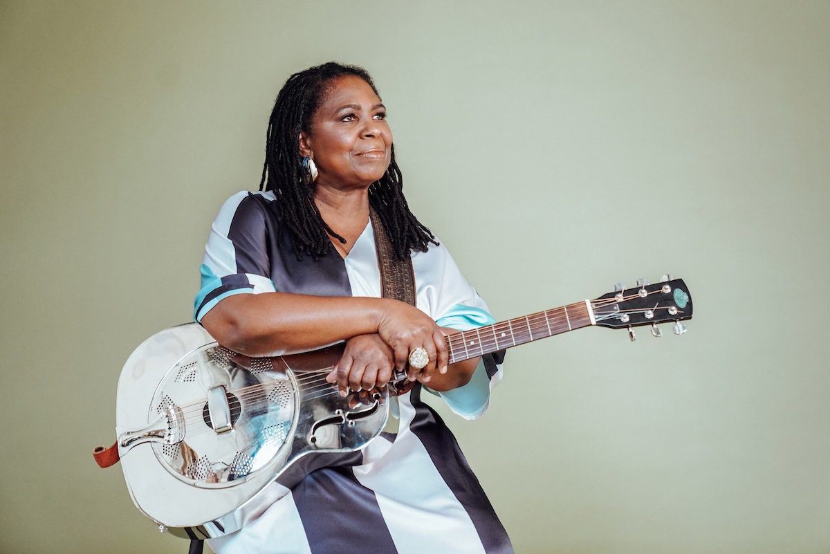 Ruthie Foster holding a metal resonator guitar